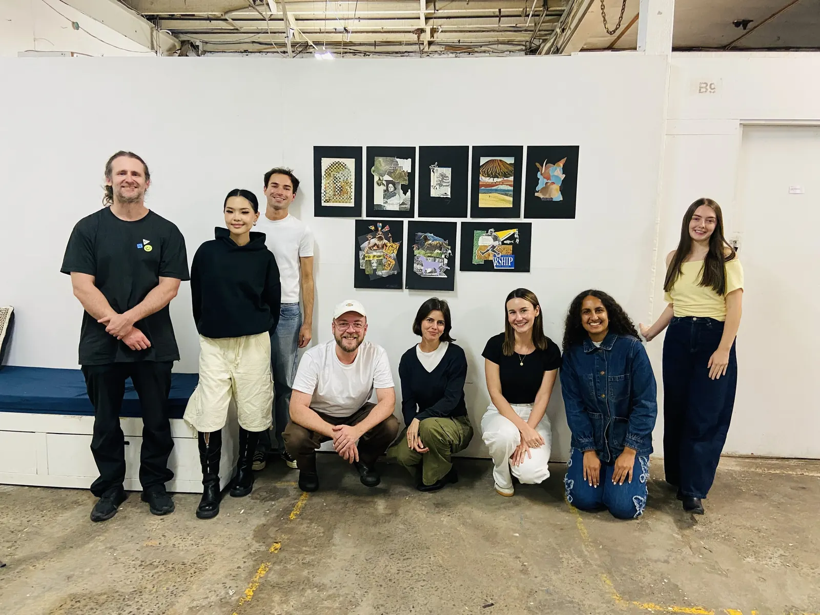 A team standing in front of their finished collages hung on the wall